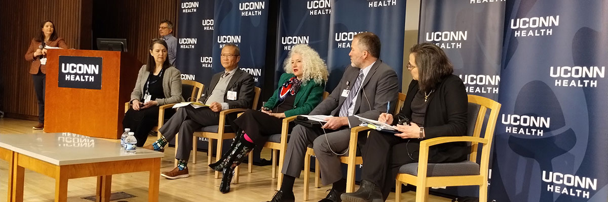 five speakers seated on stage